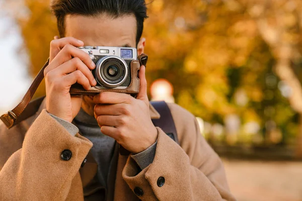 Young Man Wearing Coat Taking Photo Retro Camera While Walking — Stock Photo, Image
