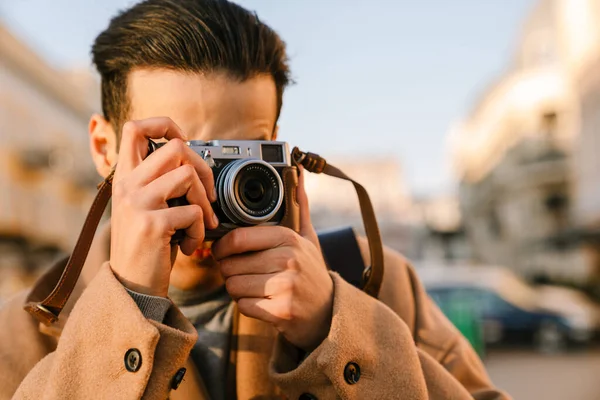 Young Man Wearing Coat Taking Photo Retro Camera While Walking — Stock Photo, Image