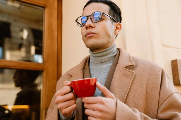 Молодой Человек Очках Пьет Кофе Стоя Городской Улице — стоковое фото