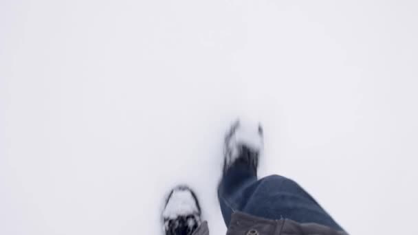 Ноги Человека Черных Сапогах Джинсах Идущего Зимой Снегу Пов Видео — стоковое видео