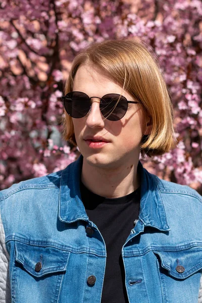 Young Long Hair Man Sunglasses Denim Jacket Front Blossoming Peach — Fotografie, imagine de stoc