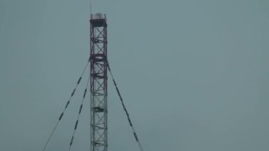 Top of cell tower in the fog clouds