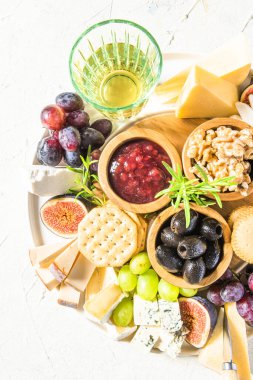 Tasty Appetizer Cheese Board with Various Food on Platter.