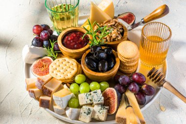 Cheese Board Various Cheese Olives,Figs Fruits, Grapes, Wine and Nuts.