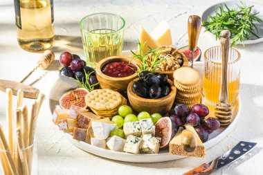 Cheese Board Various Cheese Olives,Figs Fruits, Grapes, Wine and Nuts.