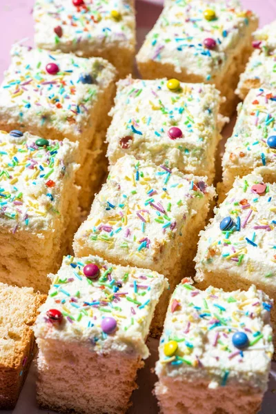 Sliced Sponge Cake Decorated Cream Sprinkles Closeup View — Stock fotografie