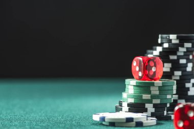 Poker Chips and Dices on Green Poker Table. Casino Background.