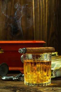 Cuban Cigar on Whisky Glass .