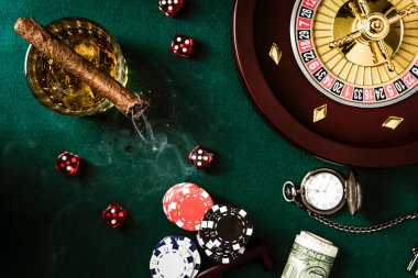 Roulette Wheel, Casino Chips on poker Table. Top Down View.