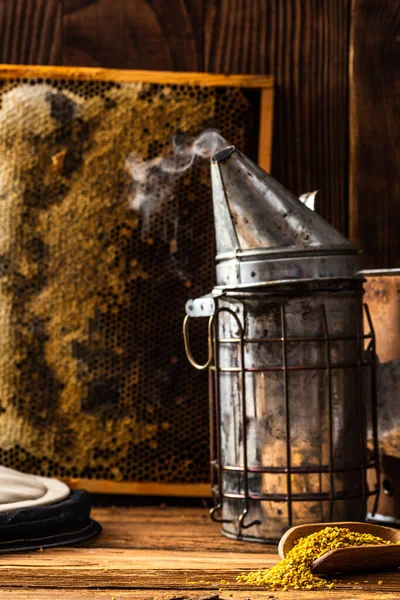 Beekeeper tools on wooden table. honey produce background.