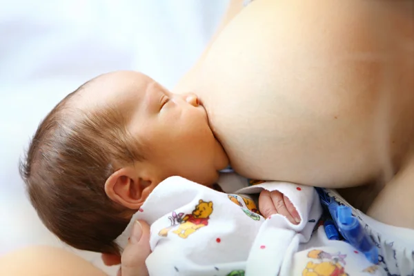 Baby sucking mother's breast — Stock Photo, Image