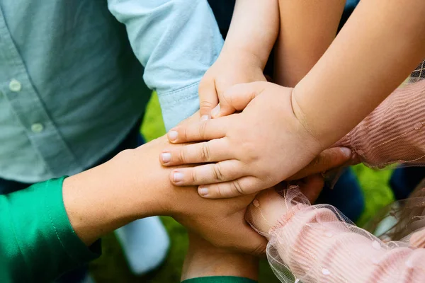 children's hands on each other, team sign
