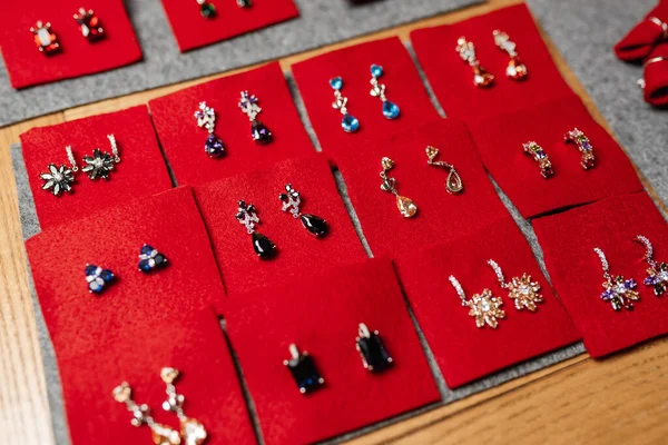 a set of earrings lies on red velvet