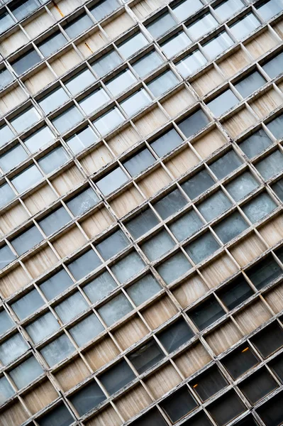 Glass grey square Windows of modern city business building skyscraper. Glass balconies in the building. Modern apartment buildings in new neighborhood. Windows of a building, texture