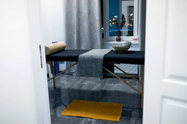 massage table with towels, head pillow in the massage room