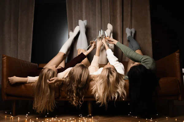 Four Beautiful Girls Stockings Lie Champagne Imagen de archivo