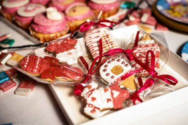 different beautiful pink gingerbread cookies on the table
