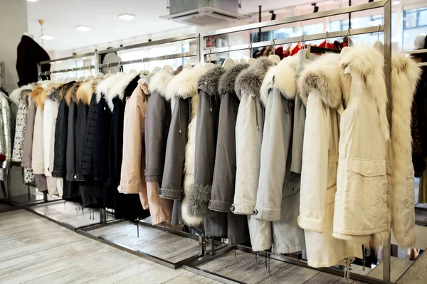 Various fur coats hang in the shop