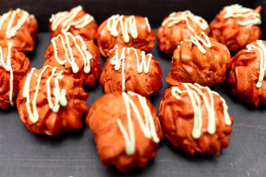 a lot of red balls cakes with white icing
