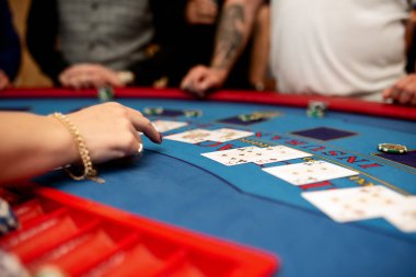 player shows two play card aces on a green table in a casino wirh chips. gambling, selective focus