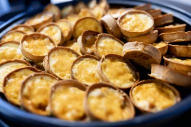 many delicious little juliennes in dough baskets