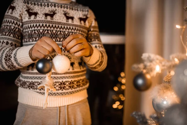 man with balls to decorate the Christmas tree