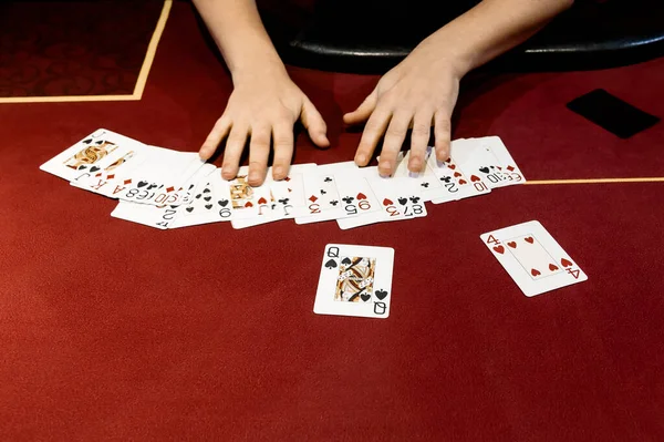 view of the hands of a girl playing poker in a casino