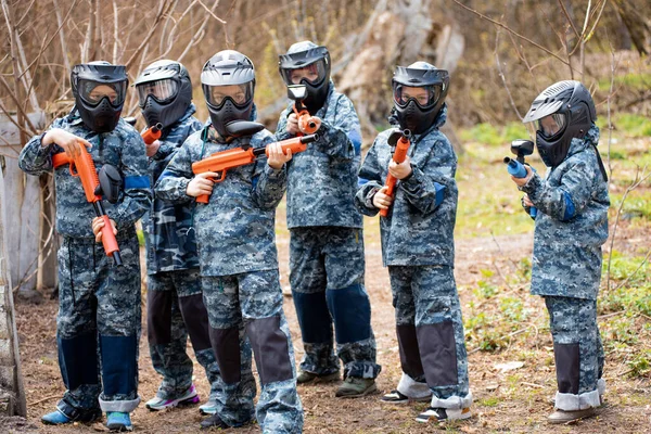 Several Children Machine Guns Paintball Masks Play War Imagen de stock