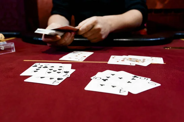 view of the hands of a man playing poker in a casino