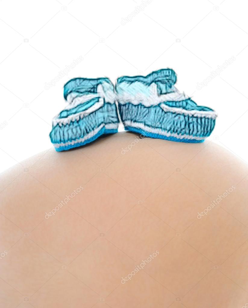 Baby booties on the belly pregnant mom