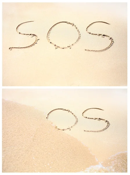 Disegno di "SOS" sulla sabbia della spiaggia — Foto Stock