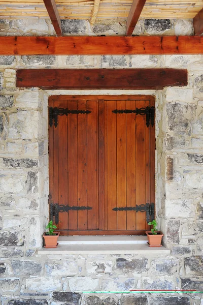 Wooden window in the stone wall — Stock Photo, Image