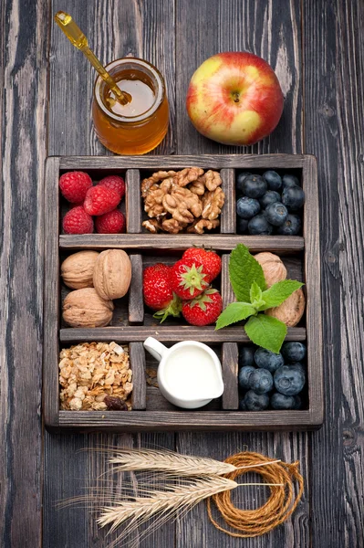 Granola muesli with berries, fruit,  honey, nuts and milk. Concept of healthy food
