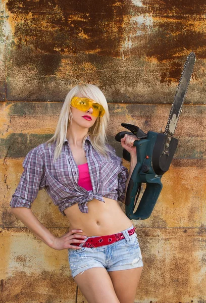 Sexy Girl holding a chainsaw — Stock Photo, Image
