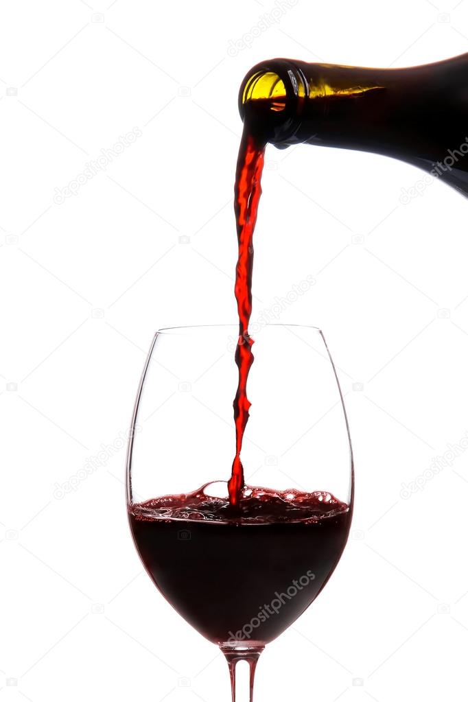 Red wine pouring down from a wine bottle isolated on white