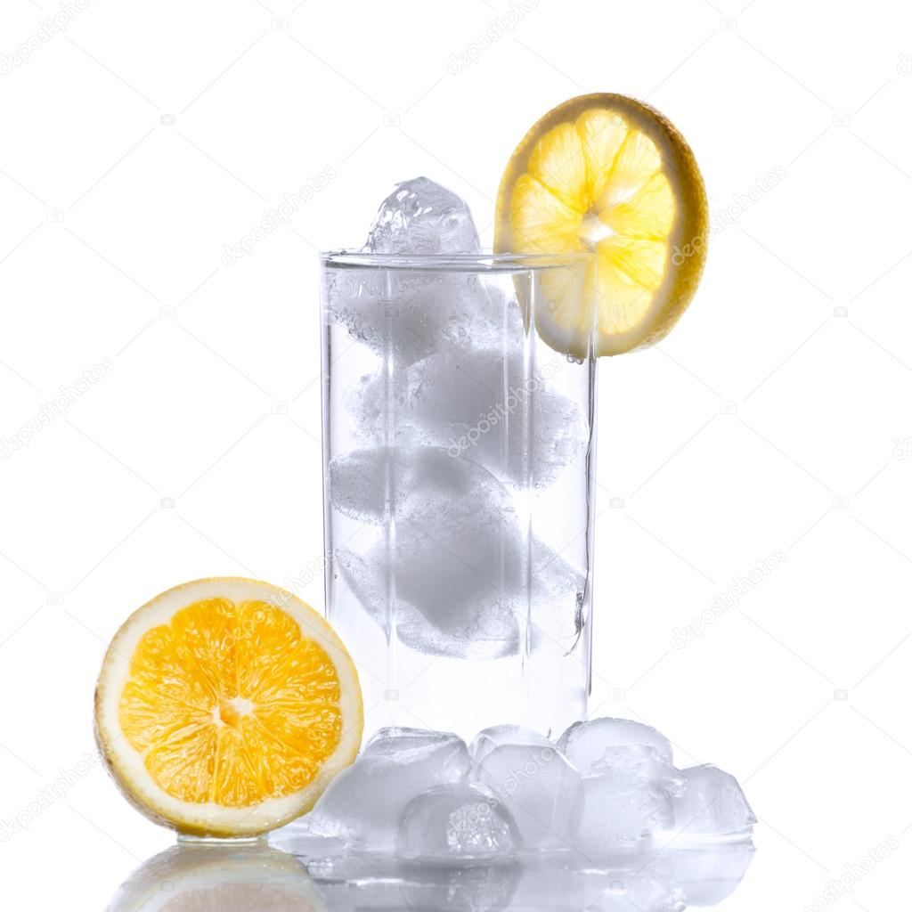 Glass with water, ice cubes and a slice of lemon