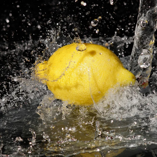 Frischwassertropfen auf Zitrone auf schwarzem Hintergrund — Stockfoto