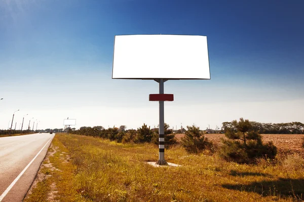 Road in a village with an empty billboard — Stock Photo, Image