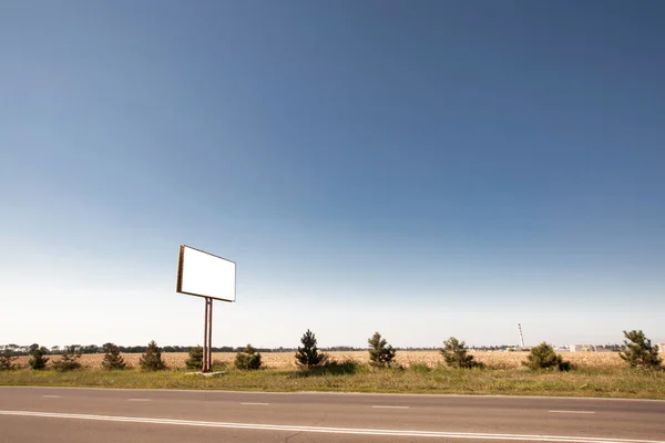 Road in a village with an empty billboard — Stock Photo, Image