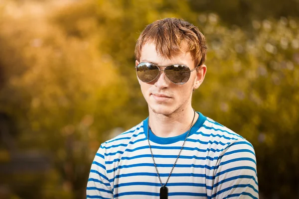 Retrato de un joven con gafas de sol al aire libre — Foto de Stock