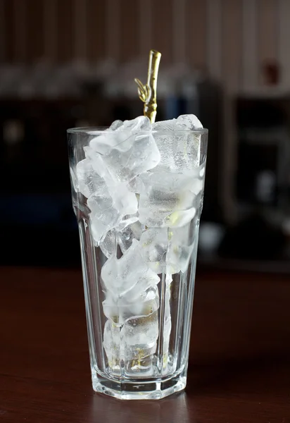Glass with ice cubes on the bar. — Stock Photo, Image