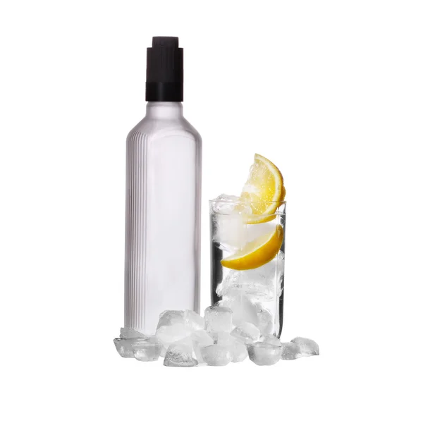 Bottle of vodka and wine glass with lemon and ice isolated on wh — Stock Photo, Image