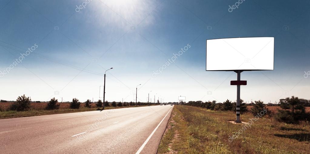 Road in a village with an empty billboard
