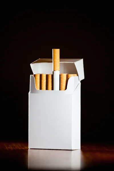 Pack of cigarettes isolated on black background,small depth of f — Stock Photo, Image