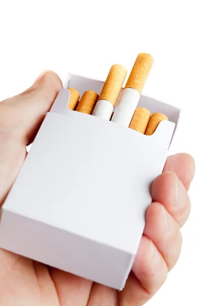 Pack of cigarettes in hand, isolated on white background — Stock Photo, Image