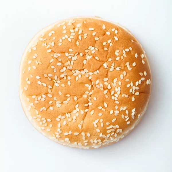 Close-up of burger bun with sesame seeds — Stock Photo, Image