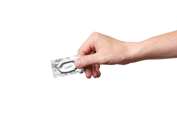 Preservativo in mano, isolato su sfondo bianco — Foto Stock