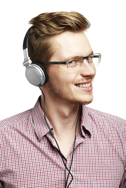 Listens and smiles with headphones — Stock Photo, Image