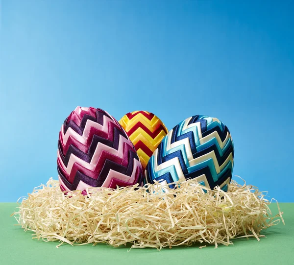 Easter eggs in hay — Stock Photo, Image