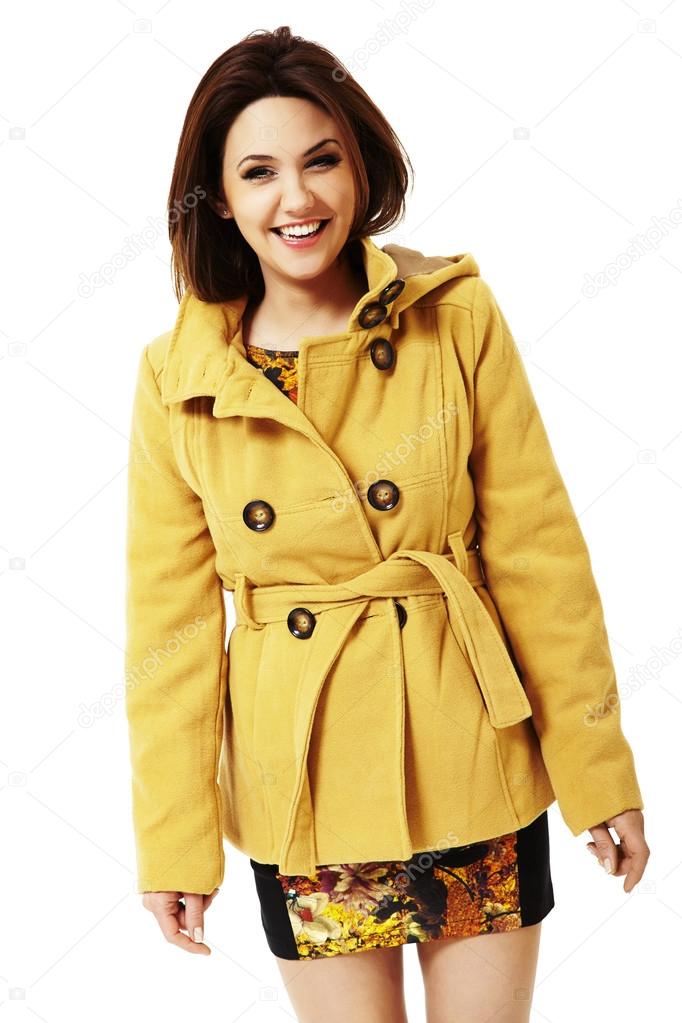 Attractive smiling woman in yellow coat